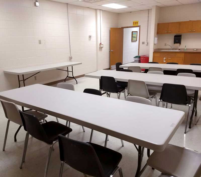 Break Room with counter and several long tables, sink
