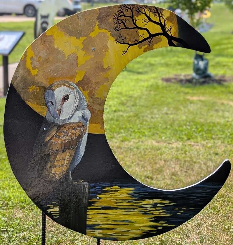 Moon cut-out with painting of an owl on it