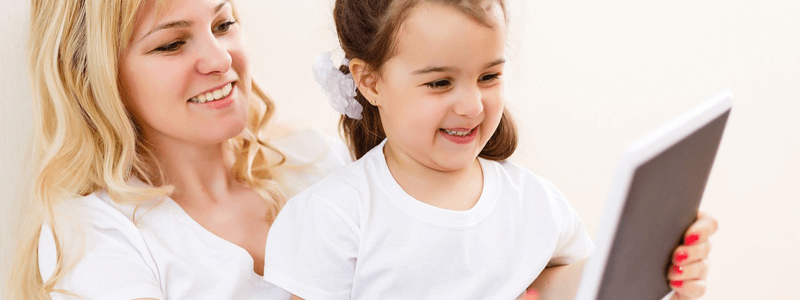 Mom and Daughter Reading together on a tablet