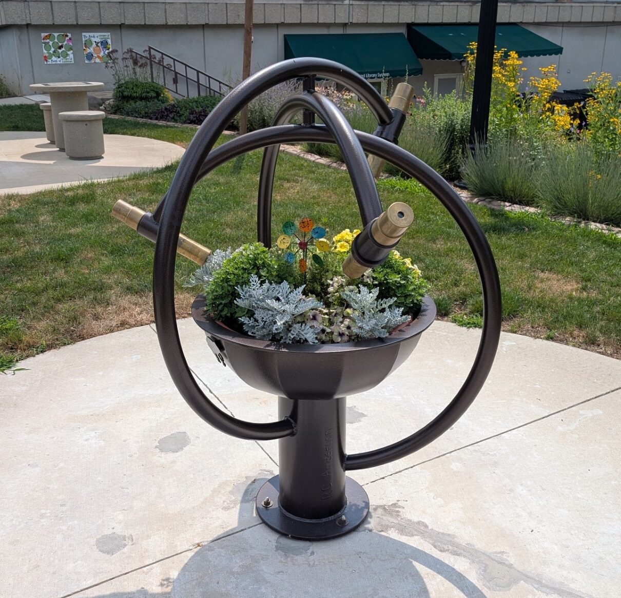 Brass Garden Kaliedoscope with three view finders and colorful foliage in the center basin