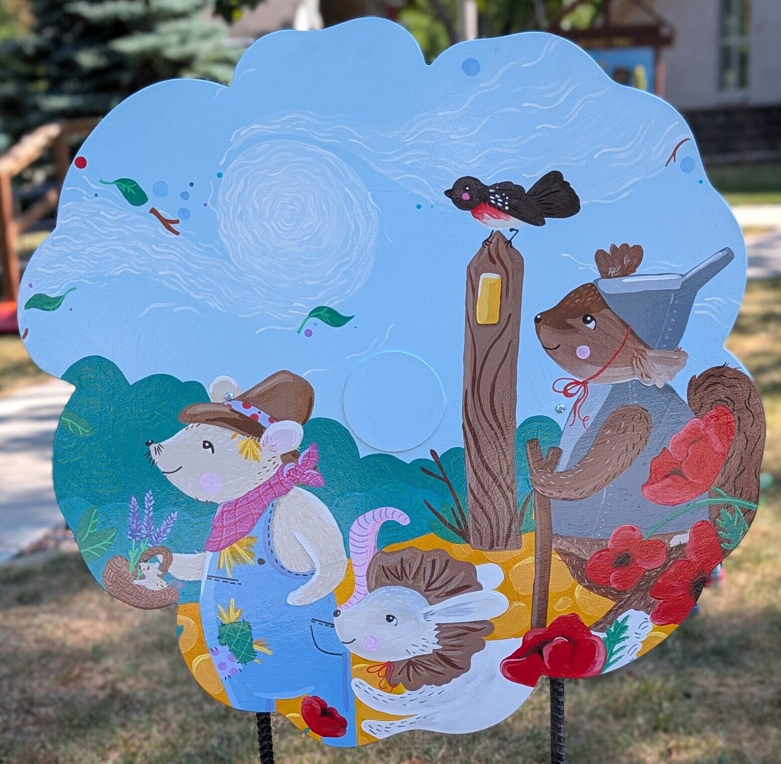Poppy cut-out with a painting of cartoon animals dressed as The Wizard of Oz characters hiking the Ice Age Trail