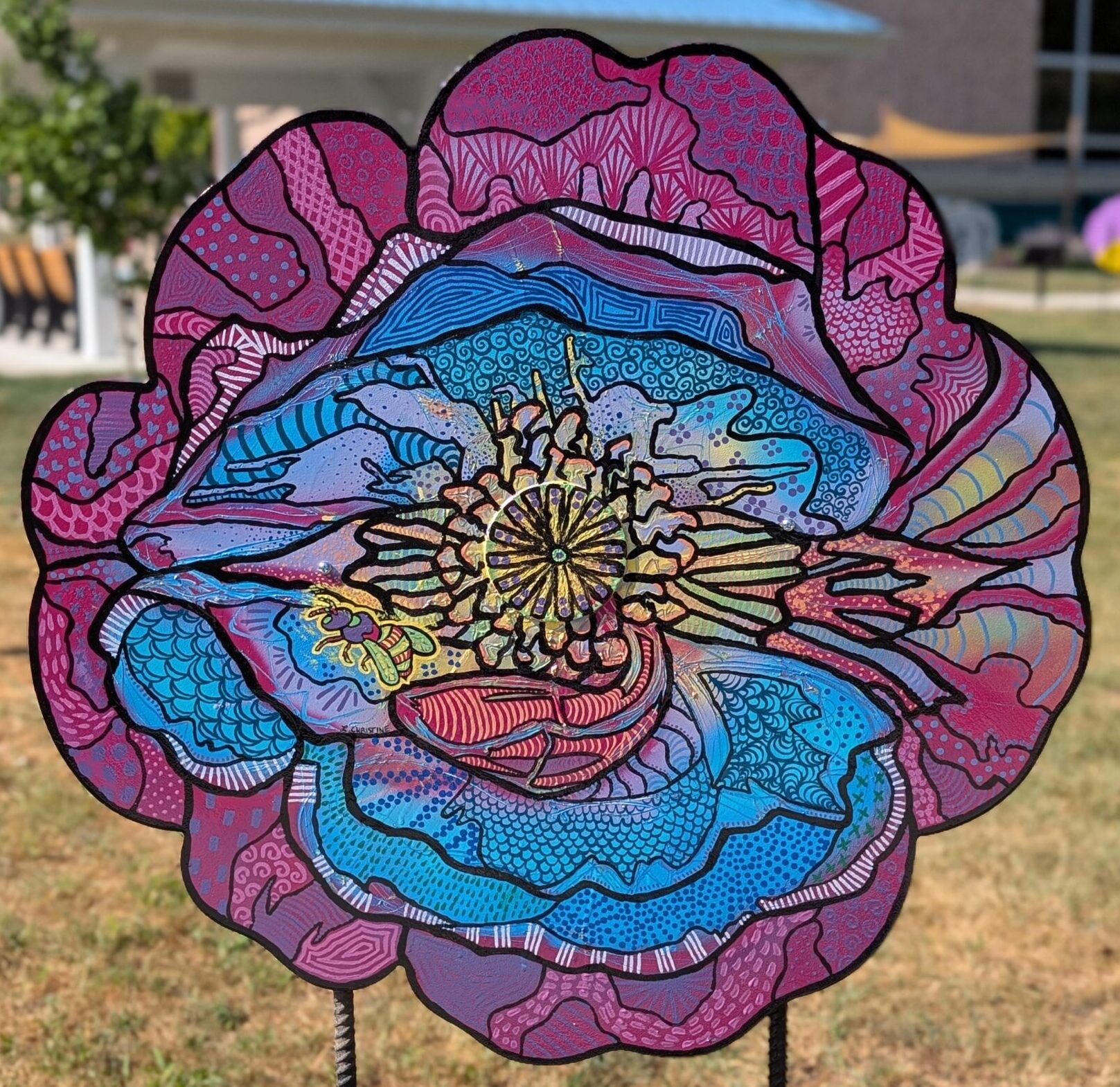 Poppy cut-out with colorful zentangle painting on it