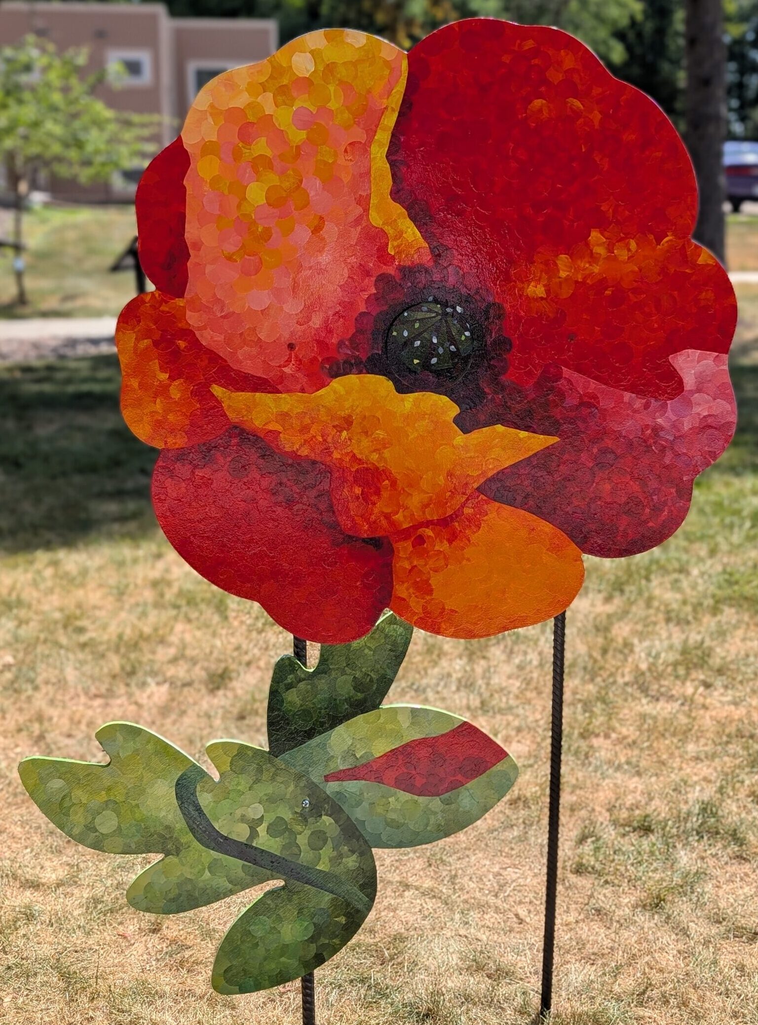 Poppy cut-out painted with an impressionoistic style of a red poppy